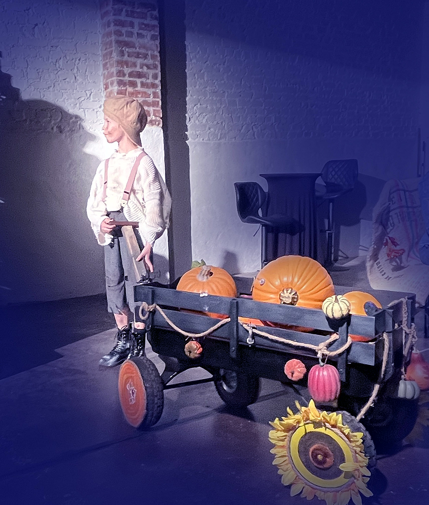 The Pumpkin Wagon: Jane Curry as the Pumpkin Kid standing beside a wagon full of pumpkins